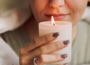 Side,Portrait,Of,Young,Calm,Woman,Holding,Lit,Candle,In