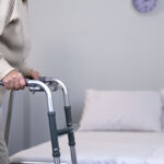 Old woman with frame, trauma rehabilitation, joint surgery, phys