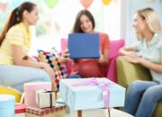 Presents and pregnant woman with friends at baby shower party